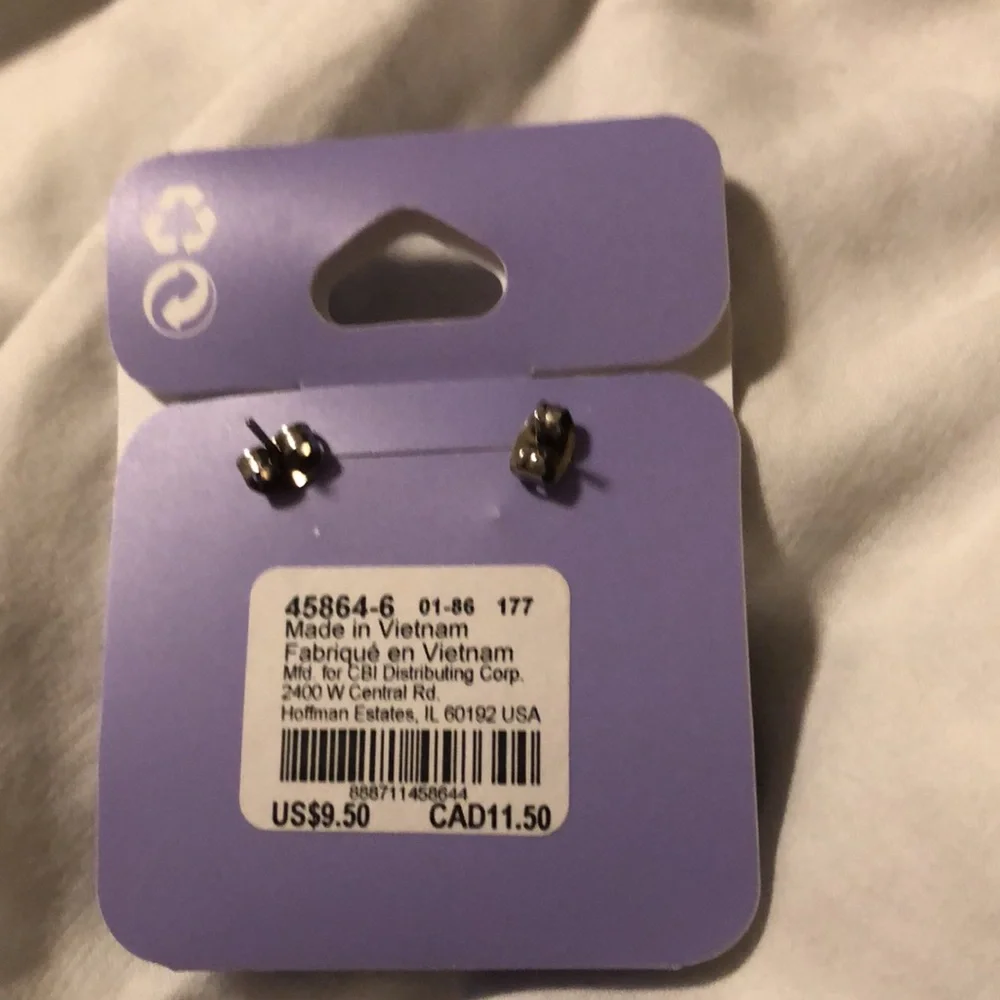 Claire’s purple flower earrings. They measure 1/4 inch each. New never worn.